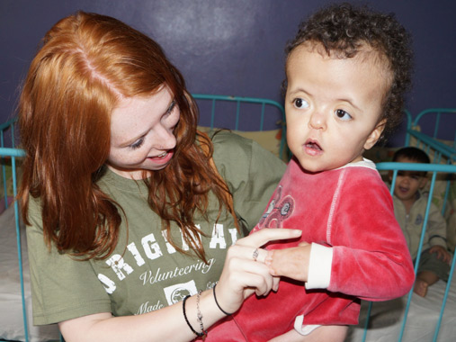 Volunteer with infant at baby orphanage in Marrakesh