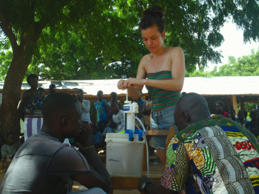 Volunteer tests new water filter for community in Ghana.