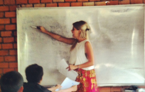 Volunteer at front of class in village school in Cambodia.