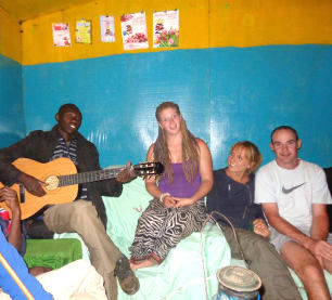 volunteer-gather-at-masai-home-for-singing-stories-card-games