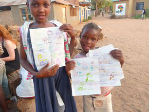 tanzania-children-show-off-colourful-school-work